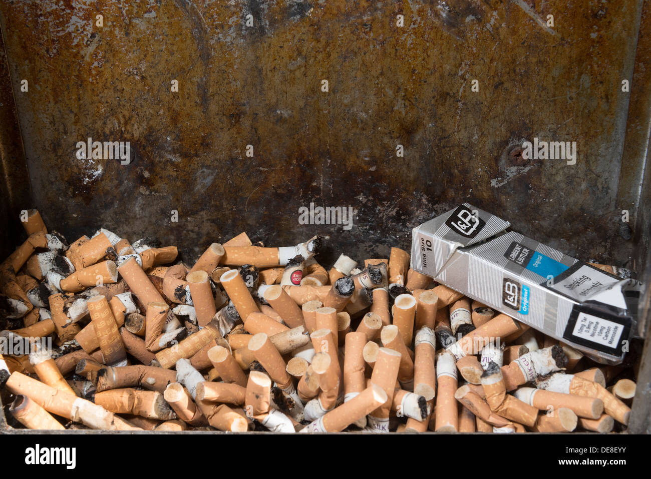 Cigarette ashtray full of stubs. butts.Smoking Damages Your Health. Stock Photo