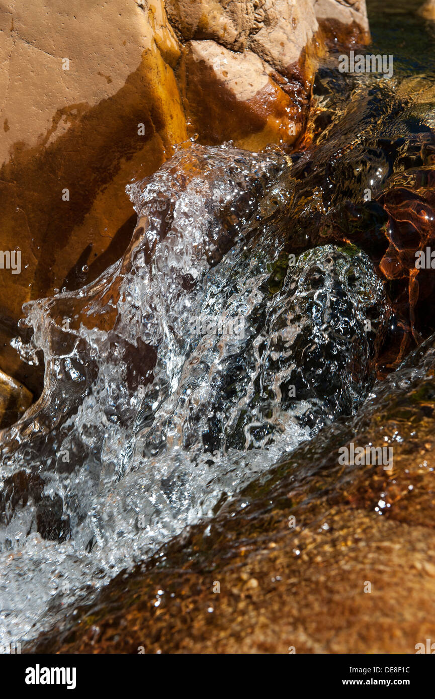 Closeup of a water stream splashing over a rock, Swartberg mountain range, Western Cape, South Africa Stock Photo