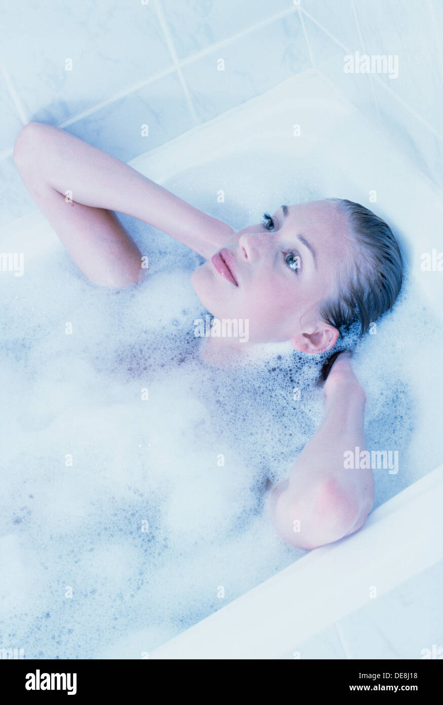 Woman washing hair bubble bath water bathroom hires stock photography