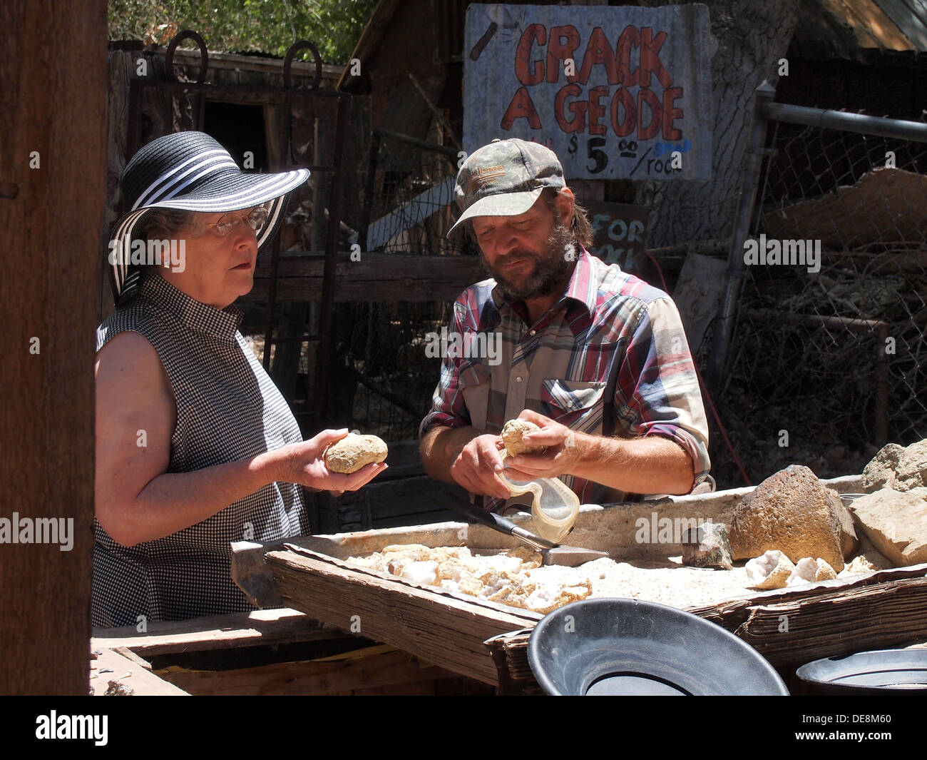 Woman tourist making a transaction with geode salesman at the Gold King Mine gift shop in Jerome, Arizona, USA Stock Photo