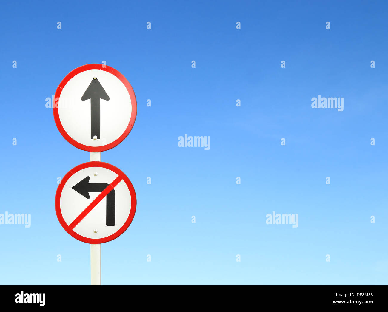 go ahead the way ,forward sign and don't turn left sign with blue sky blank for text Stock Photo