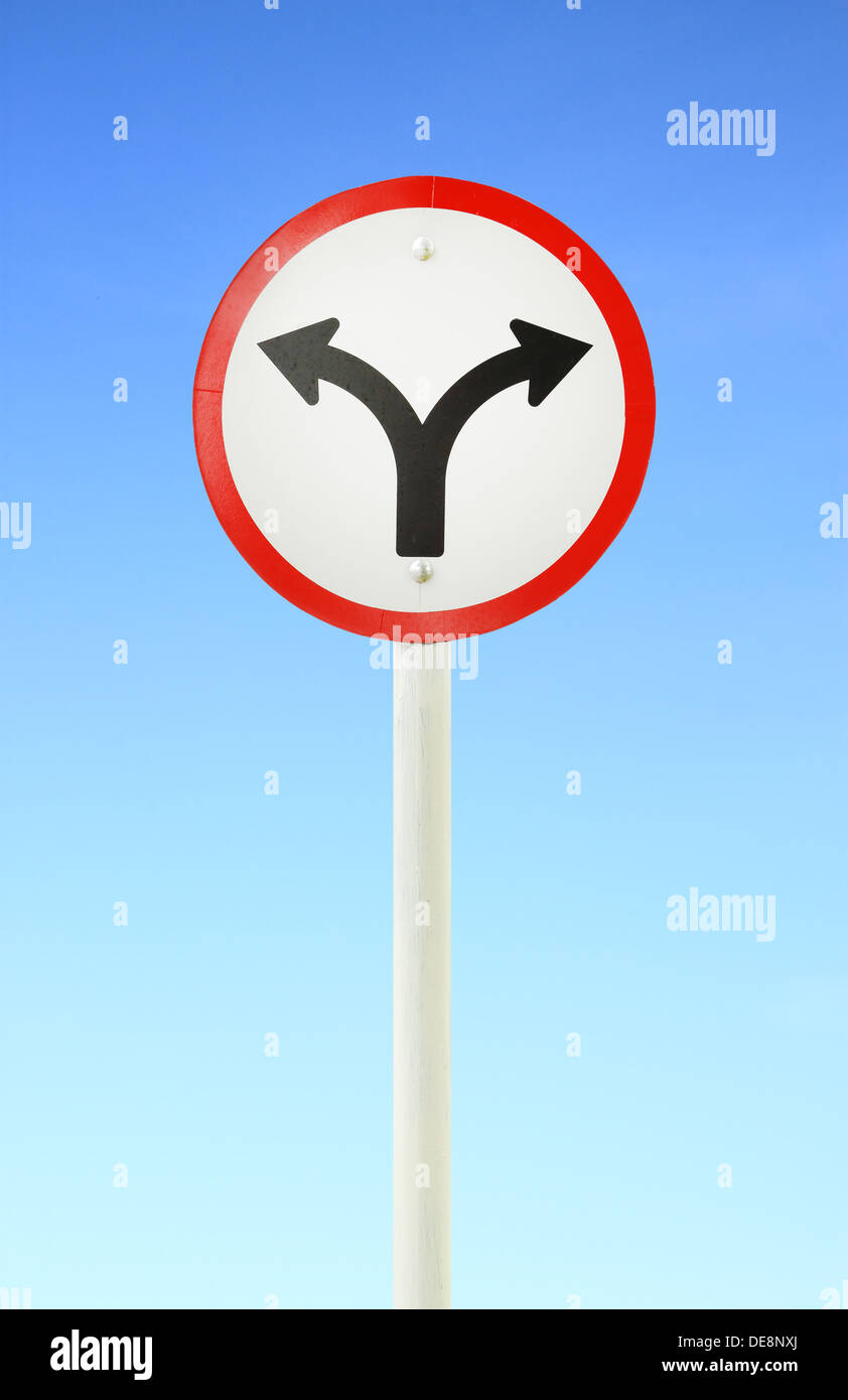 fork junction traffic sign with blue sky Stock Photo