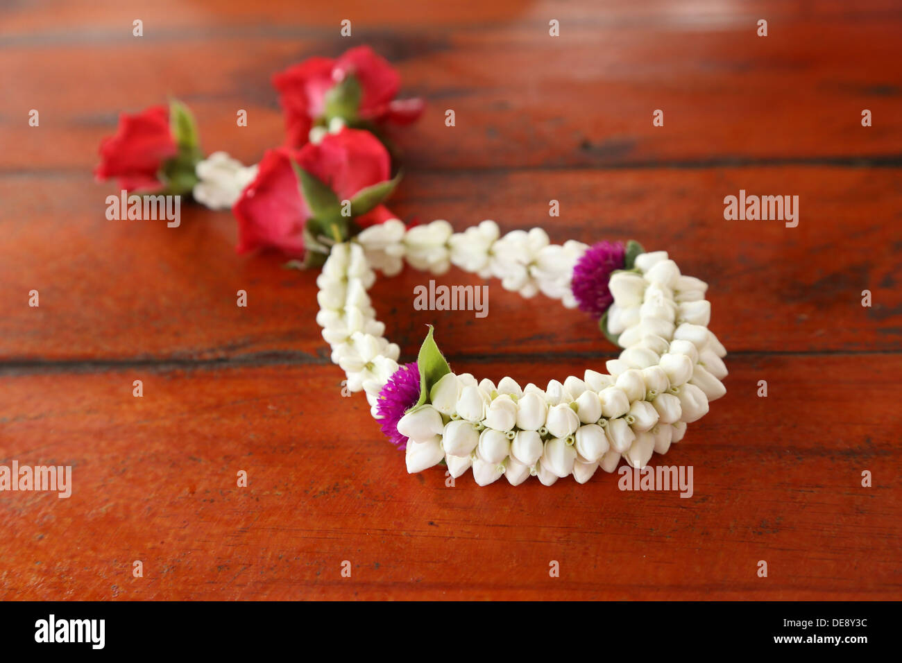Garland of jasmine flower on wood background Stock Photo