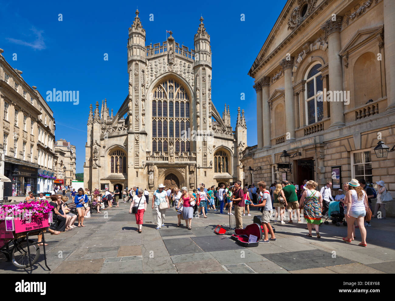 Crowds of people in front of Bath Abbey and entrance to the Pump Rooms Bath city centre Somerset England UK GB EU Europe Stock Photo