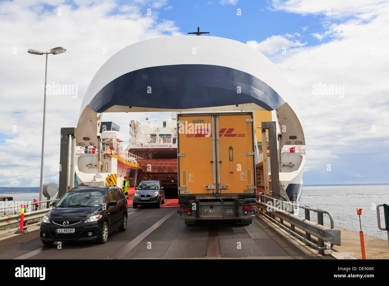 Cars disembarking and DHL lorry embarking on Oslofjord ferry to Moss from the terminal in Horten, Vestfold, Norway, Scandinavia Stock Photo