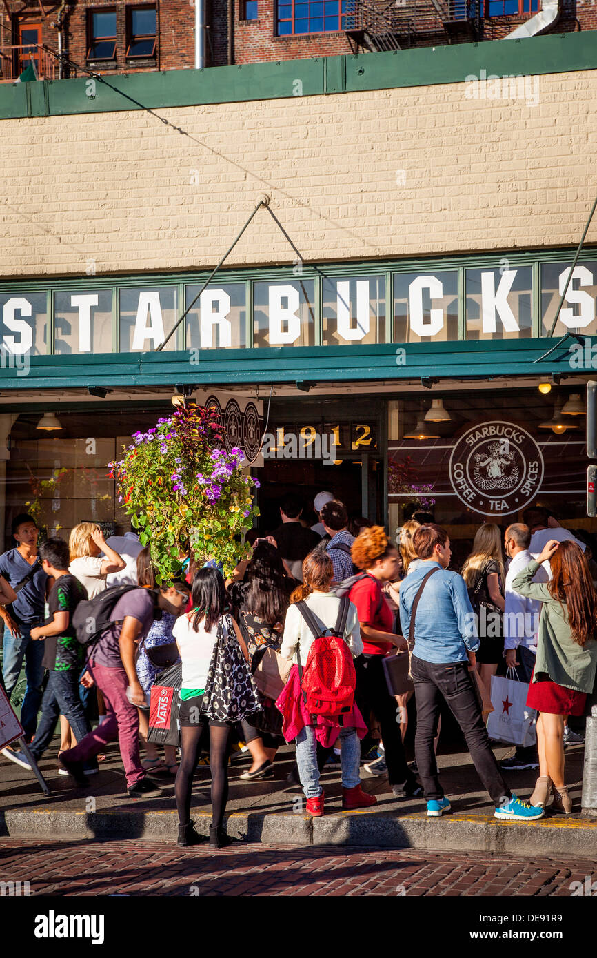 Crowd of people surrounding the original Starbucks Coffee Shop at Pike Place Market, Seattle Washington USA Stock Photo