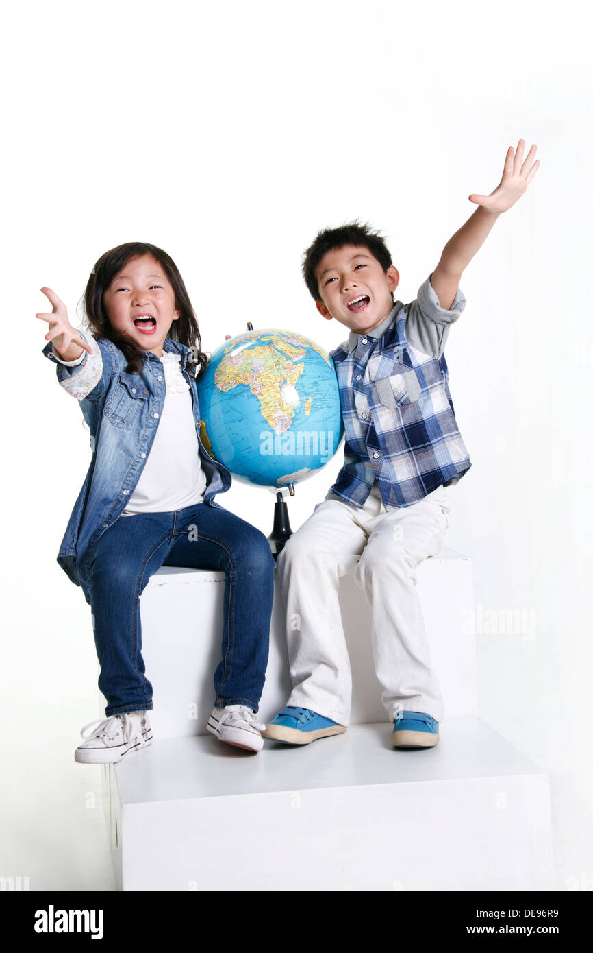 Boy and girl with globe Stock Photo - Alamy