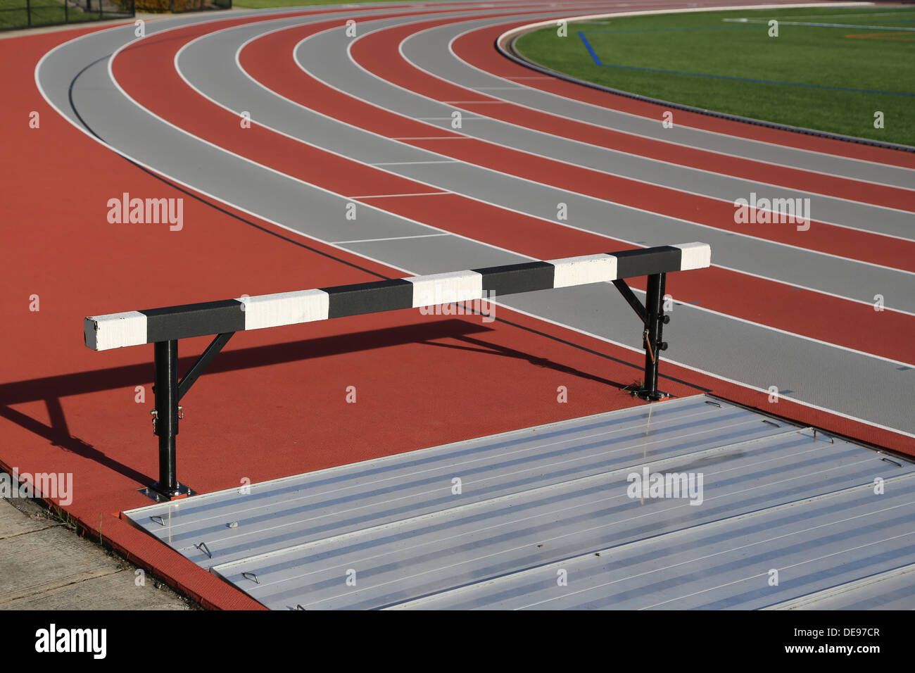 Track and athlete hurdling field Stock Photo