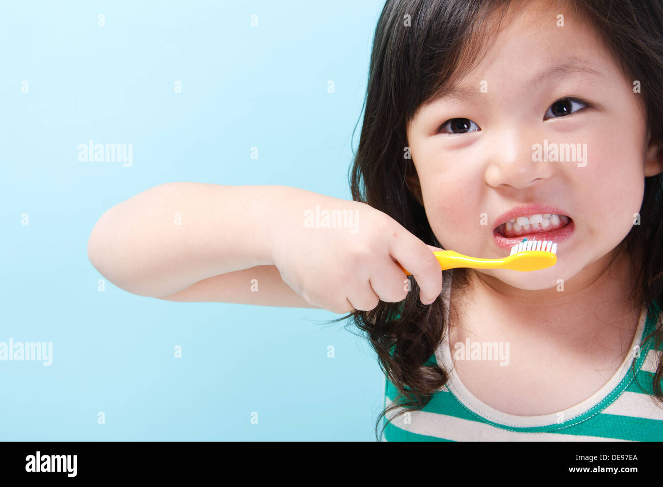 Girl brushing her teeth Stock Photo