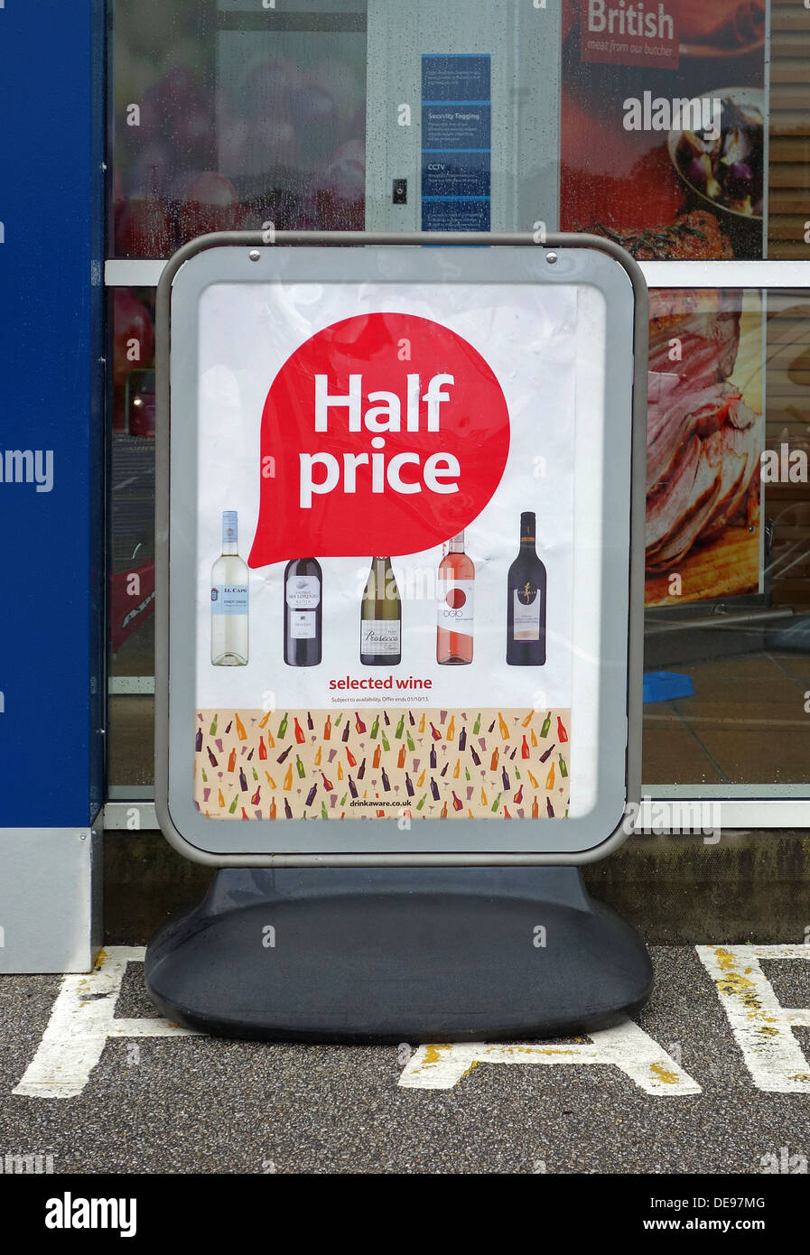 A Half Price offer poster outside a Tesco Supermarket Stock Photo