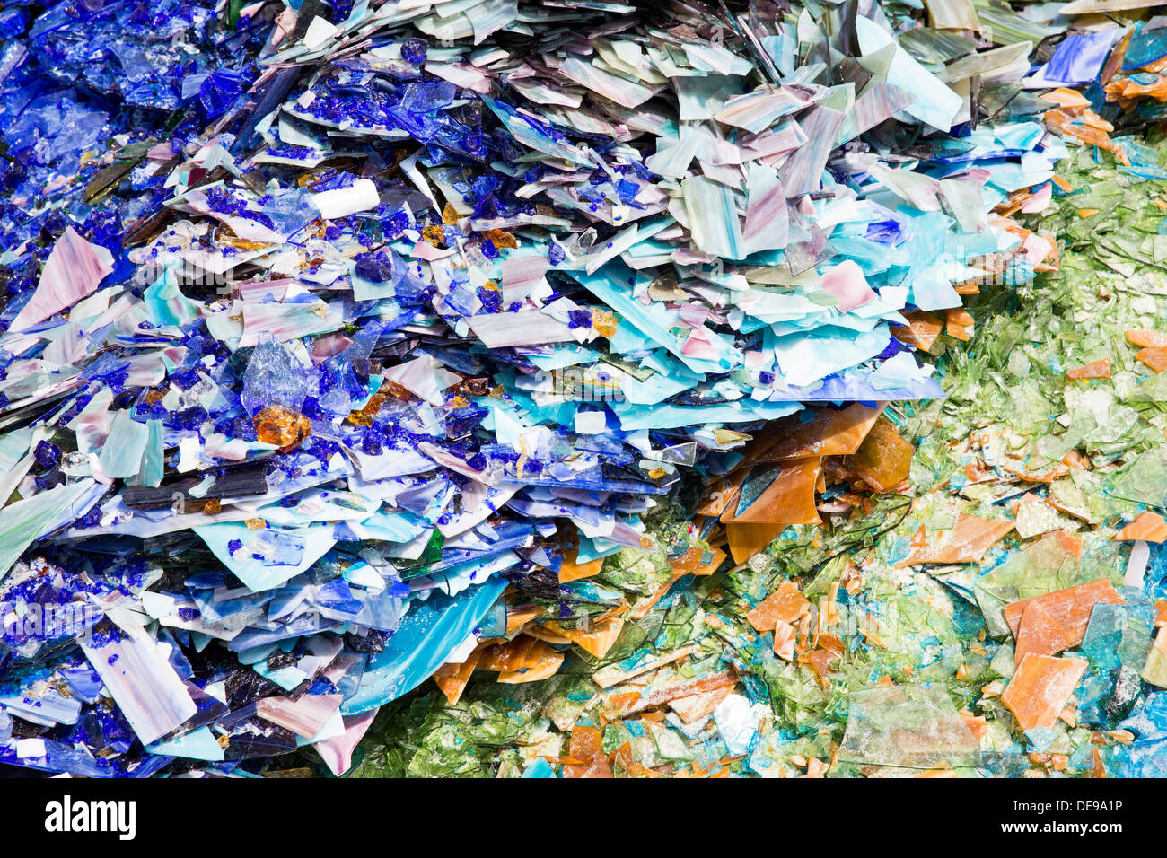 A scrap glass yard including stained glass and marbles. Stock Photo