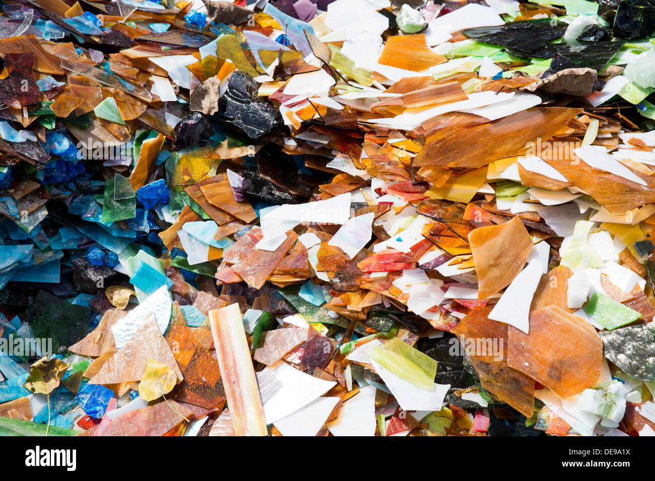 A scrap glass yard including stained glass and marbles. Stock Photo