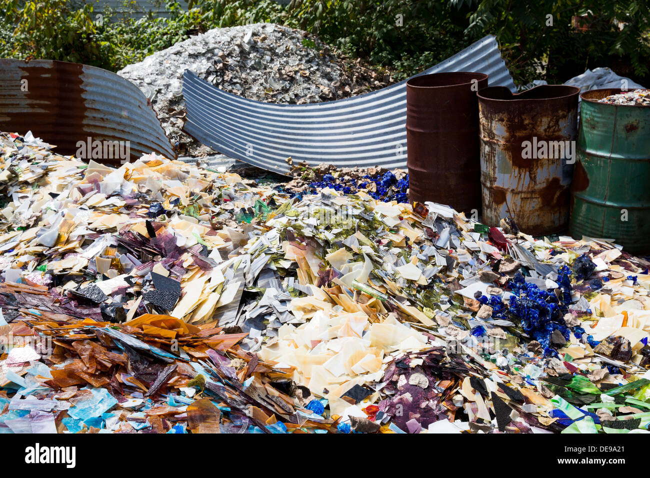 A scrap glass yard including stained glass and marbles. Stock Photo