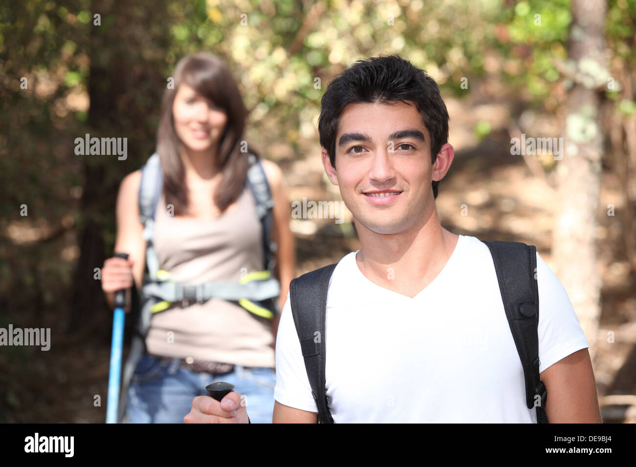Young couple hiking through forest hi-res stock photography and images ...