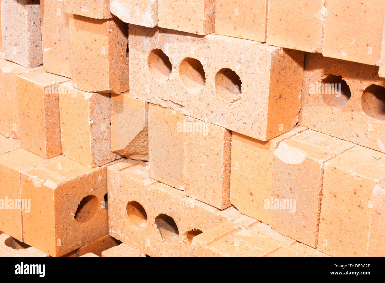 a stack of red bricks all piled up on a local construction site Stock Photo