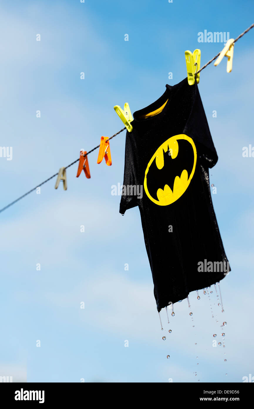 Childs wet batman t shirt hanging on a washing line. India Stock Photo