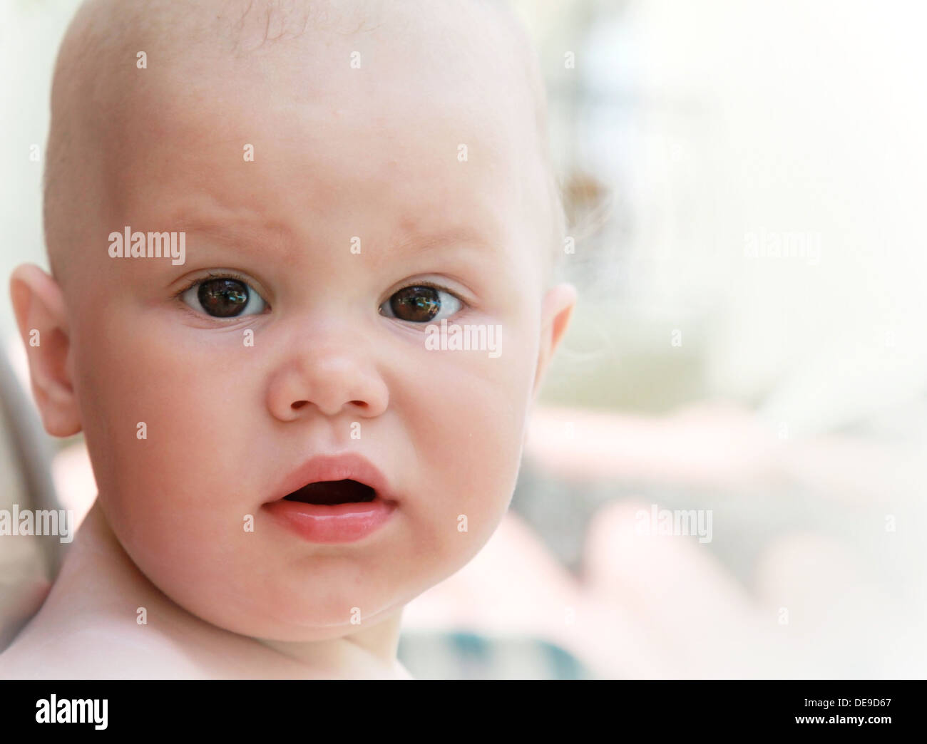Closeup outdoor portrait of surprised Caucasian baby Stock Photo