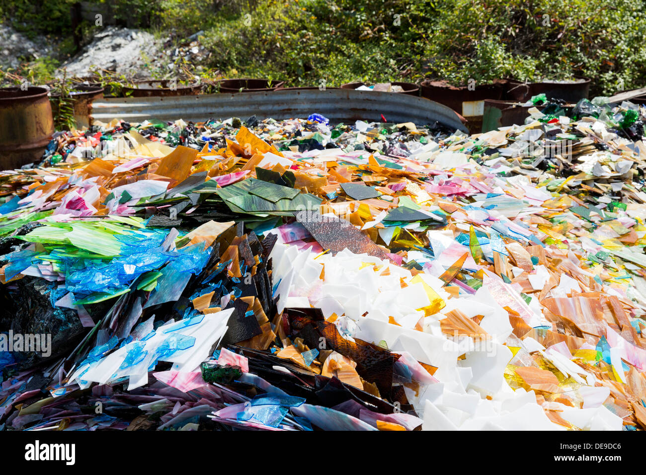 A scrap glass yard including stained glass and marbles. Stock Photo