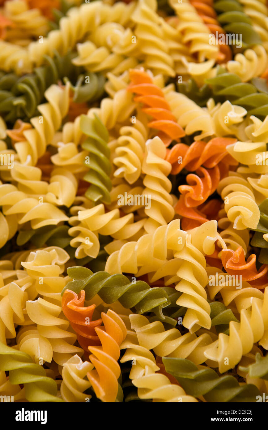 Italian fusilli or rotini, helix shaped macaroni pasta background Stock