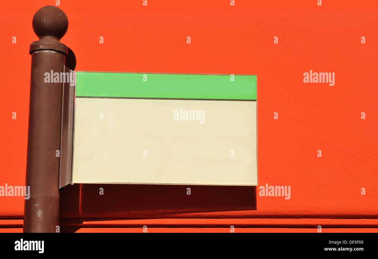 Blank direction indicator isolated against red wall Stock Photo Alamy