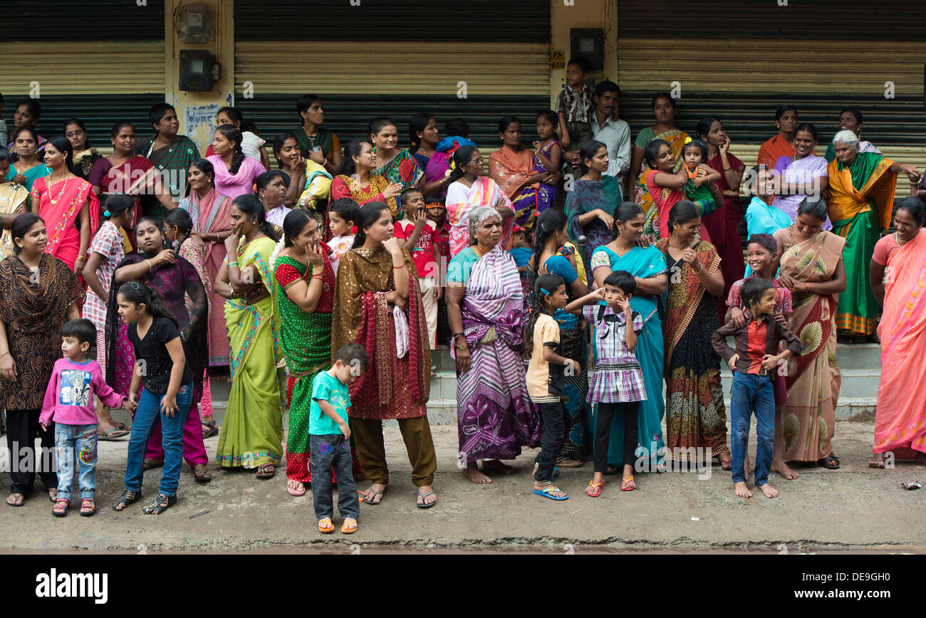 Indian women and children watching a festival parade. Ganesha Chaturthi Festival,  Puttaparthi, Andhra Pradesh, India Stock Photo