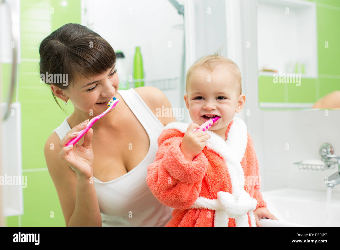 mother with baby brushing teeth Stock Photo Alamy