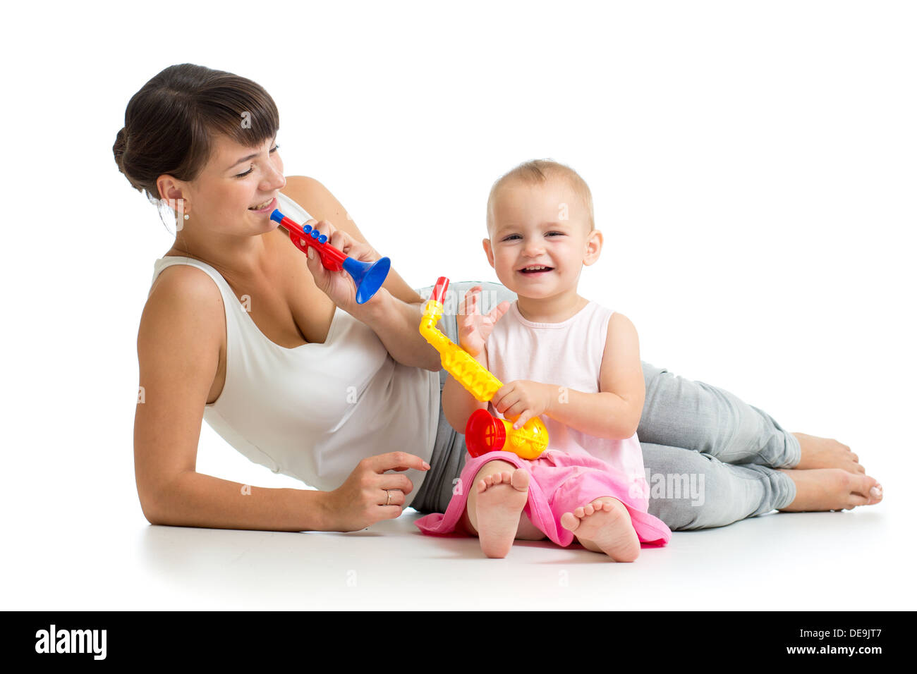 Mother and baby girl having fun with musical toys Stock Photo
