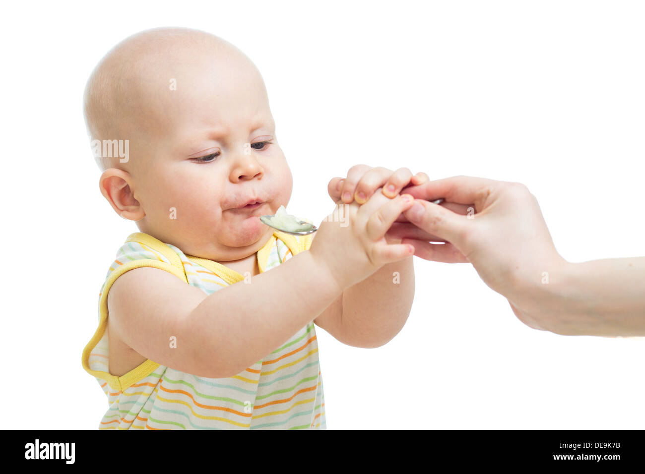 baby boy eating with a spoon Stock Photo Alamy
