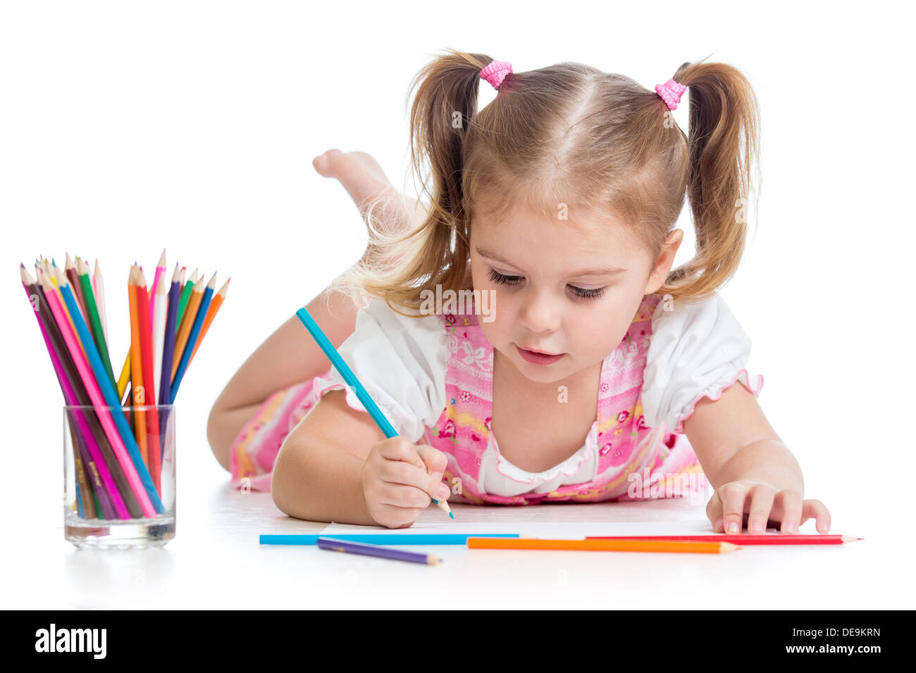 cute child drawing with colorful pencils Stock Photo