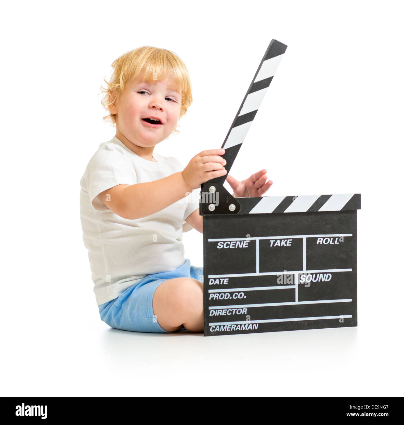 Happy baby boy with clapper board sitting on floor Stock Photo