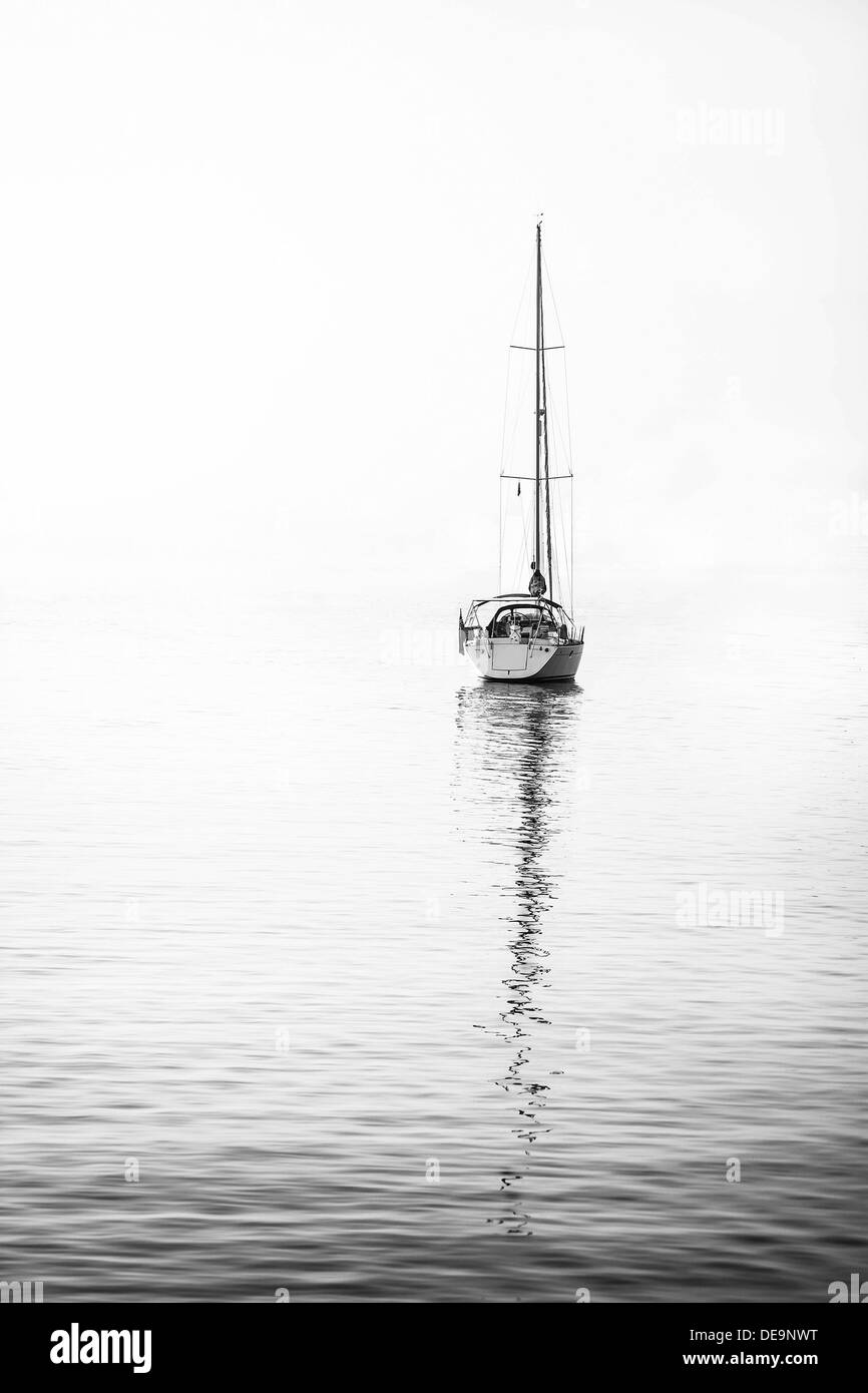 A white sailing yacht is moored in peaceful waters of a southern spanish port Stock Photo