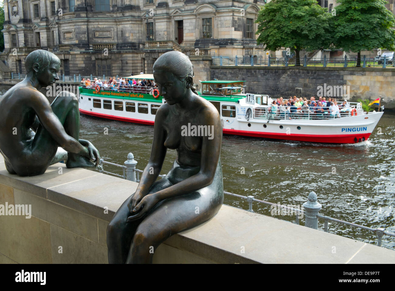 Bronze statues 'Three Girls and a Boy' beside Spree River in Mitte Berlin Germany Stock Photo