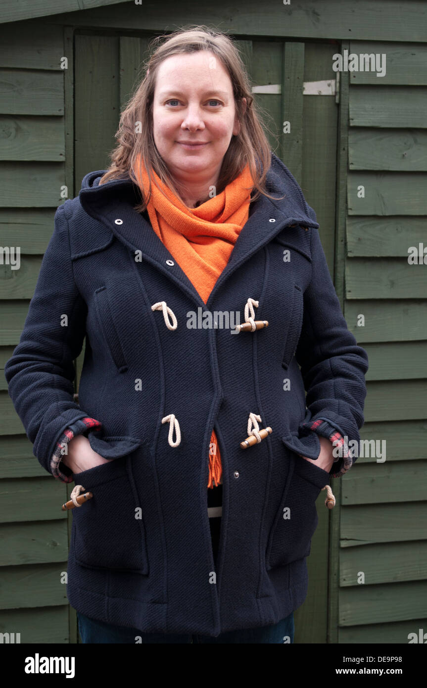 Portrait of a pregnant woman wearing orange scarf and duffle coat Stock Photo