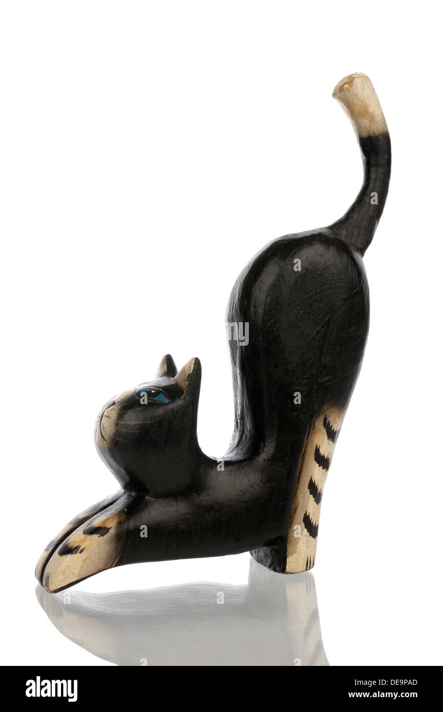 Wood carved statuette of a black kat from the left side isolated in white Stock Photo