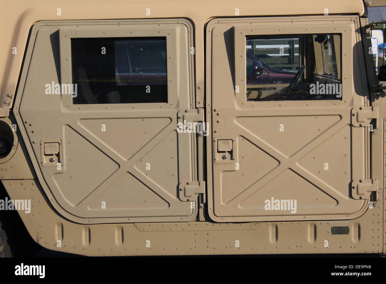 View from the side of a military personnel carrier in desert sand Stock Photo
