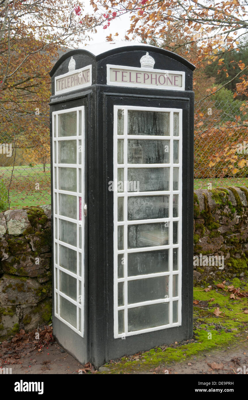Old type K6 telephone box painted black and white to match the colour scheme of Achfary village, Sutherland, Scotland, UK. Stock Photo