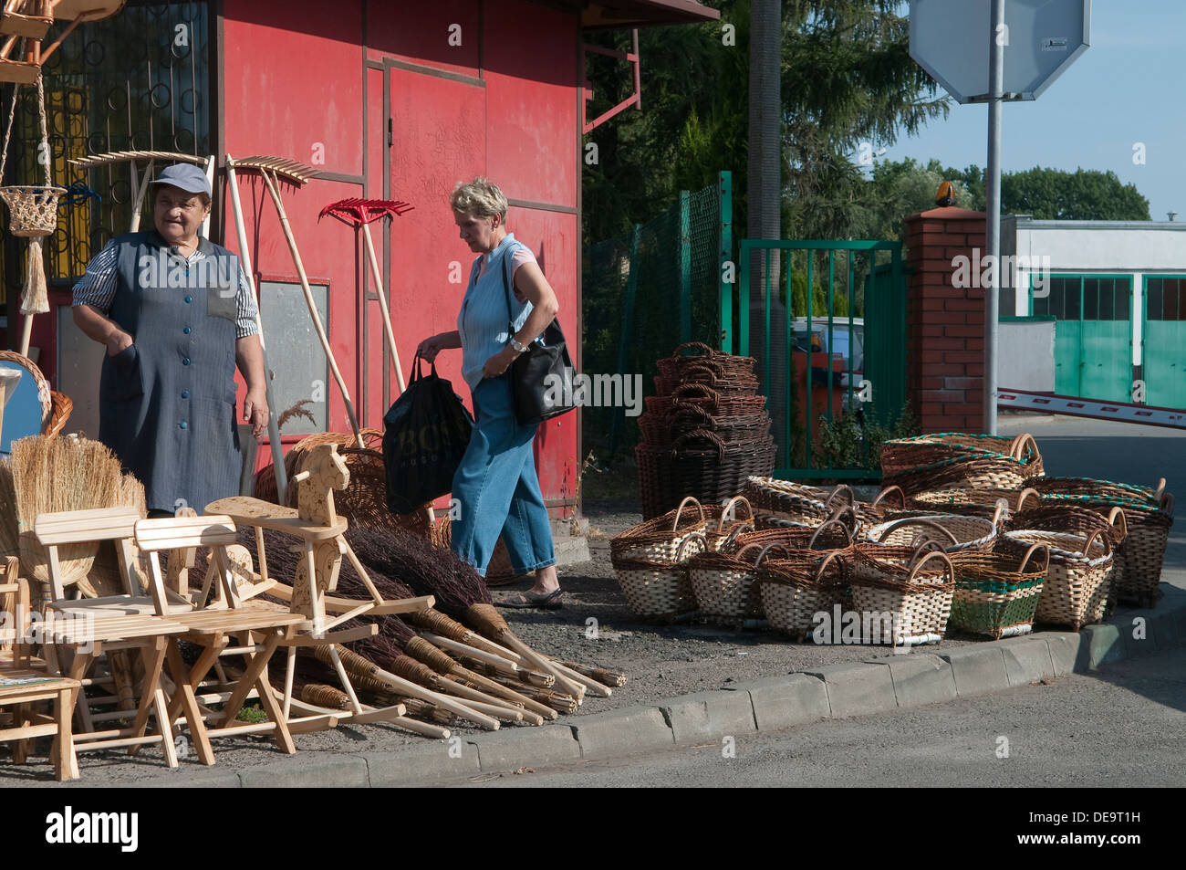 Woman selling wicker baskets and furniture at local craft fair in Wadowice, Poland. Stock Photo