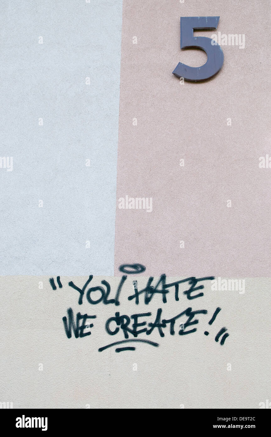 'You Hate we create' graffiti on the wall of apartments building in Poland. Stock Photo