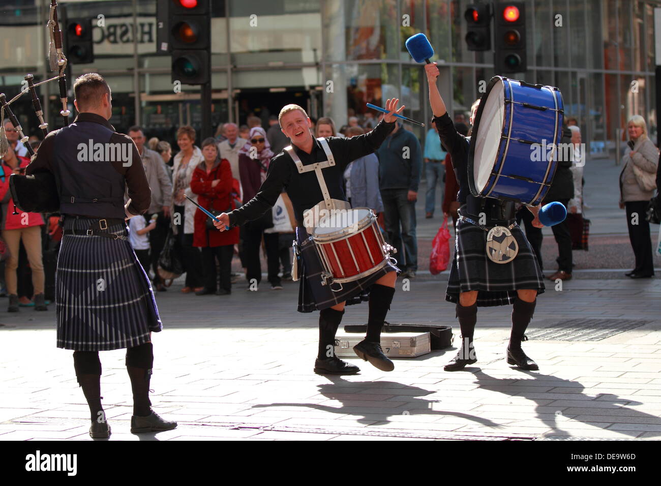 Scottish musical band playing bagpipes, and drums to a crowd in Buchanan Street, Glasgow, Scotland, UK Stock Photo