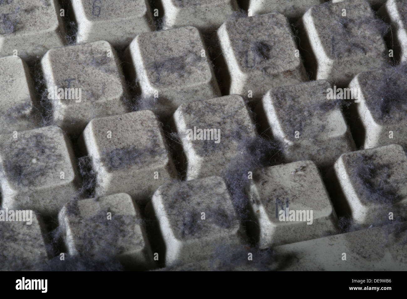 unused computer keyboard covered in dust and cobwebs Stock Photo