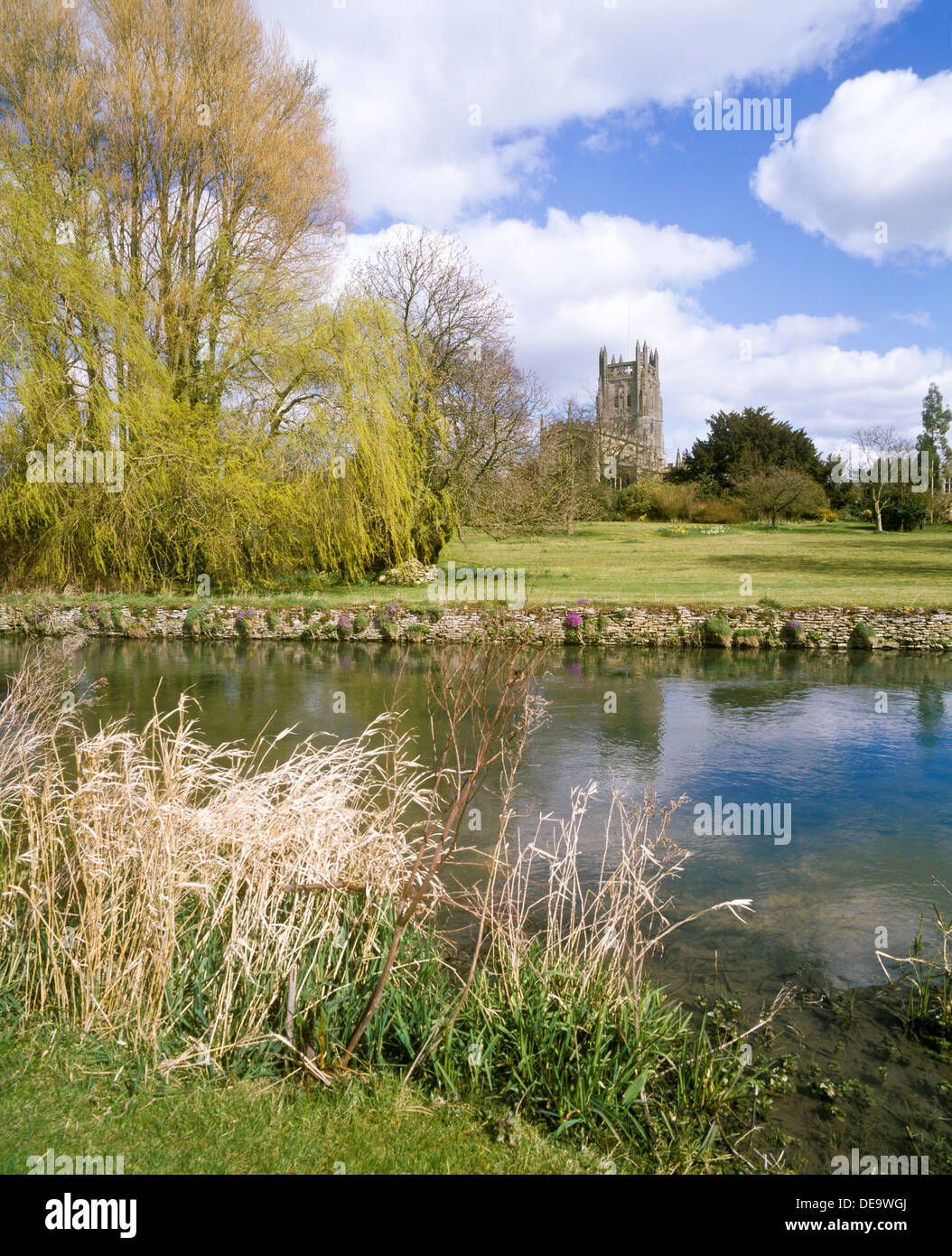 St. Mary's Church beside the River Coln in the Cotswold town of Fairford, Gloucestershire UK Stock Photo