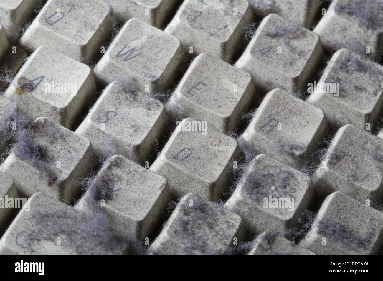 unused computer keyboard covered in dust and cobwebs Stock Photo