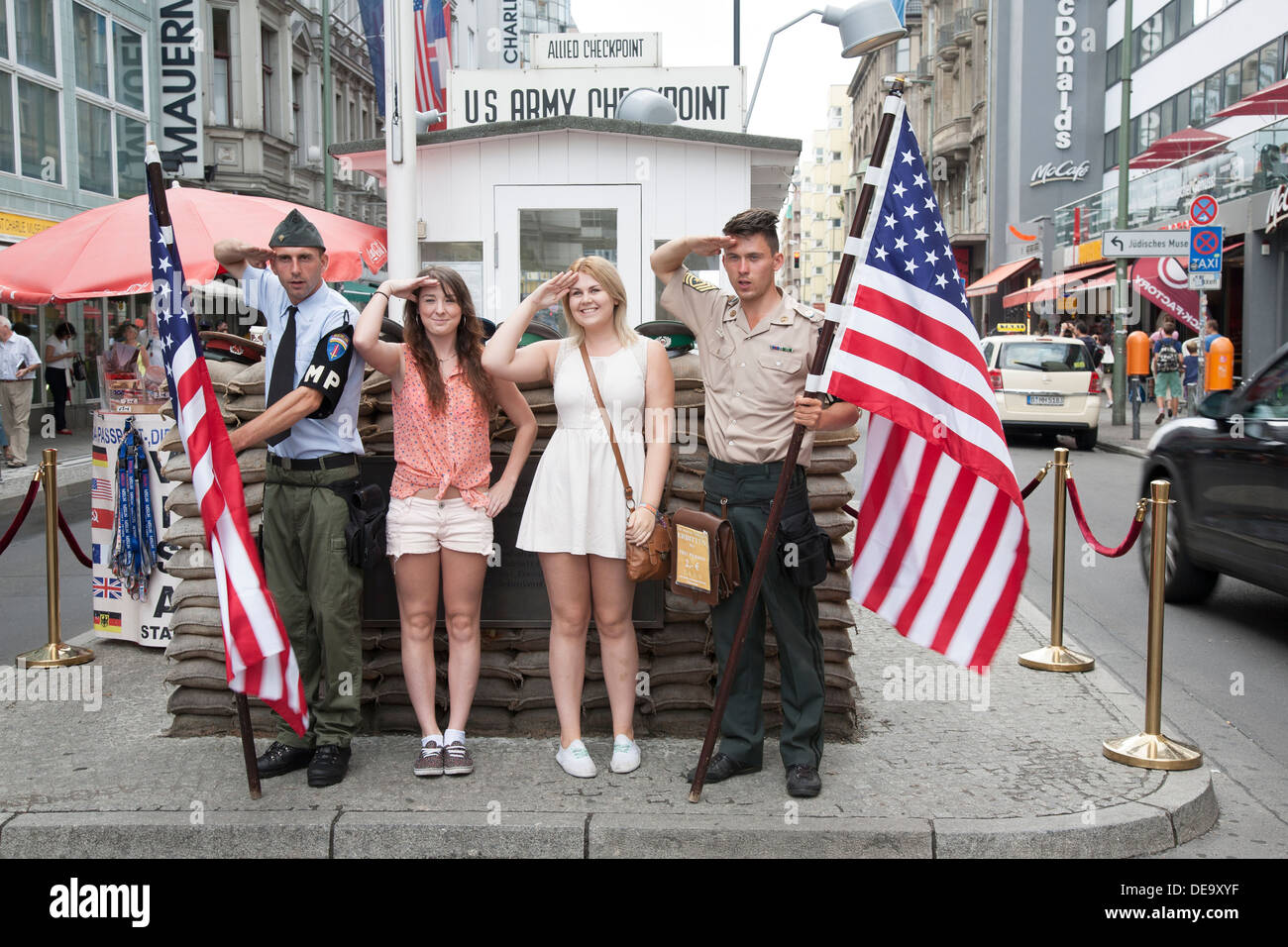 American Soldier Actors with Female Tourists at Checkpoint Charlie; Berlin; Germany Stock Photo