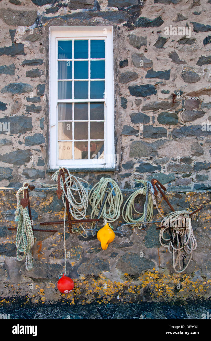 Fishing Anchors & Floats on Sea Wall, Porth Dinllaen, Llŷn Peninsula, North Wales, UK Stock Photo