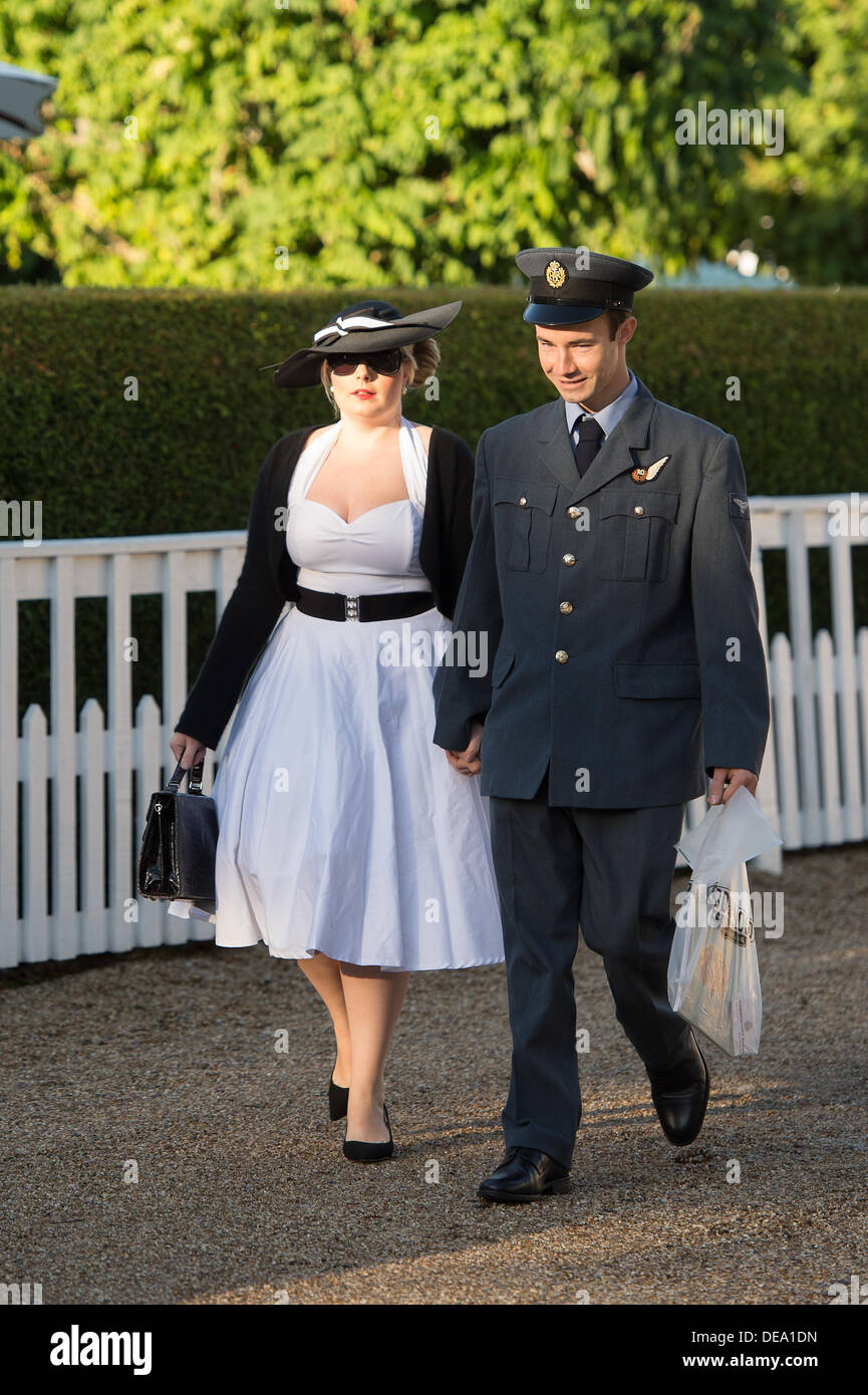 Chichester, West Sussex, UK. 14th Sep, 2013. Goodwood Revival. Goodwood Racing Circuit, West Sussex - Saturday 14th September. Two visitors to the festival dressed in an RAF uniform and period dress walk through the circuit. Credit:  MeonStock/Alamy Live News Stock Photo