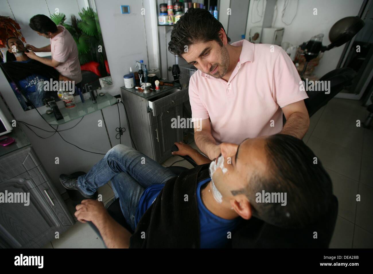 A hairdresser at his shop in the street of Damascus, Syria, on 2013-09-14. Stock Photo