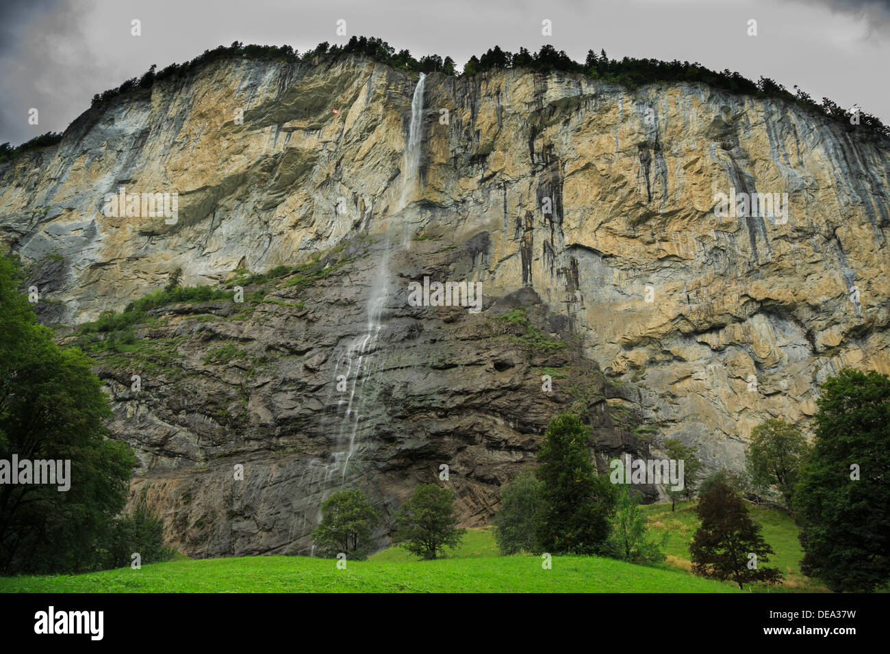 A cliff face and waterfall in Lauterbrunnen, Switzerland. The grey storm clouds give the photo a special feeling. Stock Photo