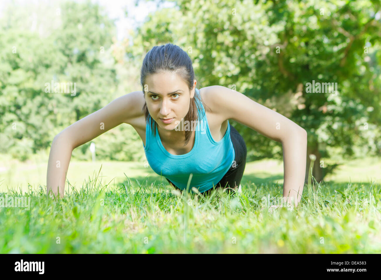 Fitness woman doing push-ups in the park Stock Photo - Alamy