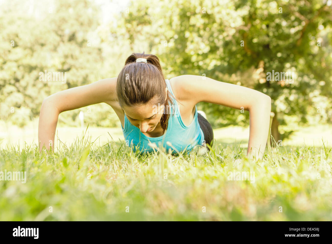 Fitness woman doing push-ups in the park Stock Photo - Alamy
