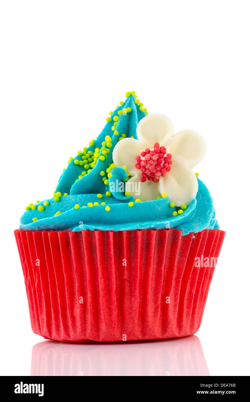 Red and blue birthday cupcake with flower isolated over white